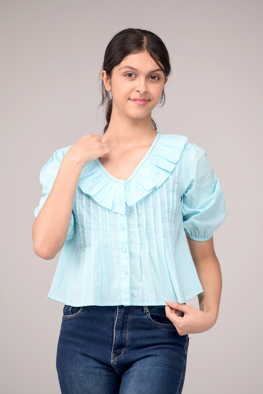 V‑neck top crowned with a dramatic ruffle