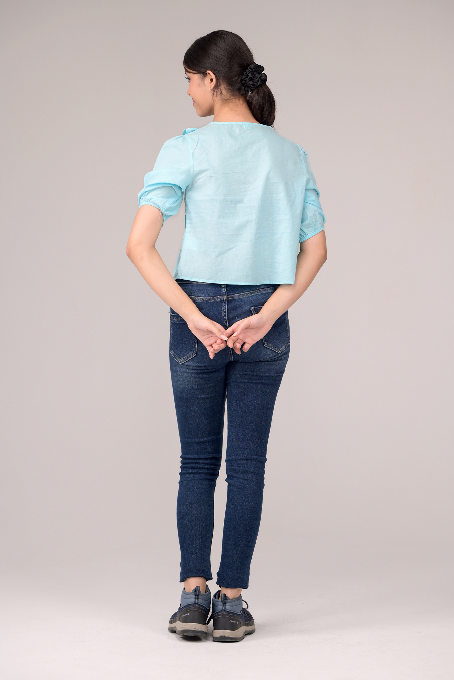 V‑neck top crowned with a dramatic ruffle