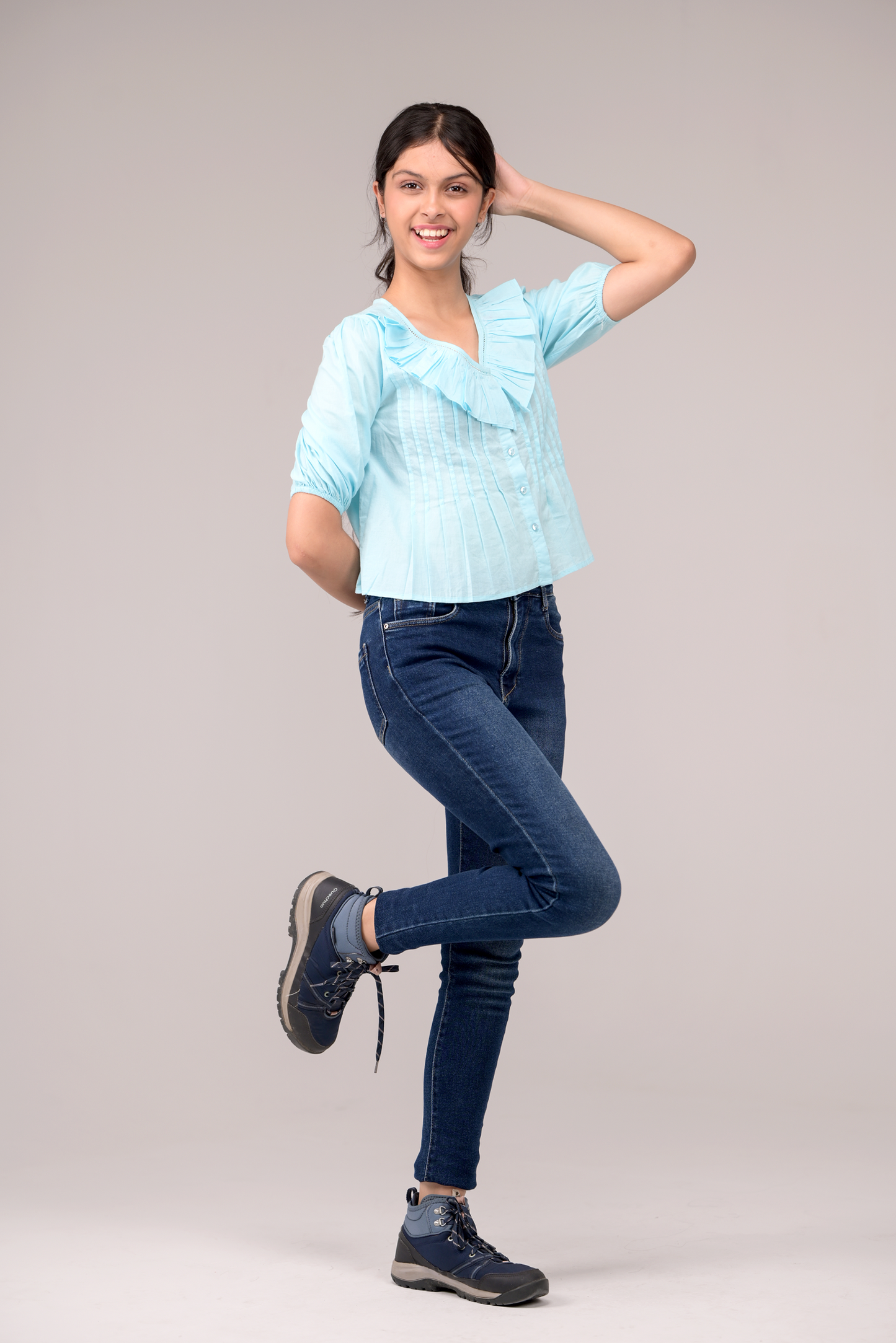 V‑neck top crowned with a dramatic ruffle