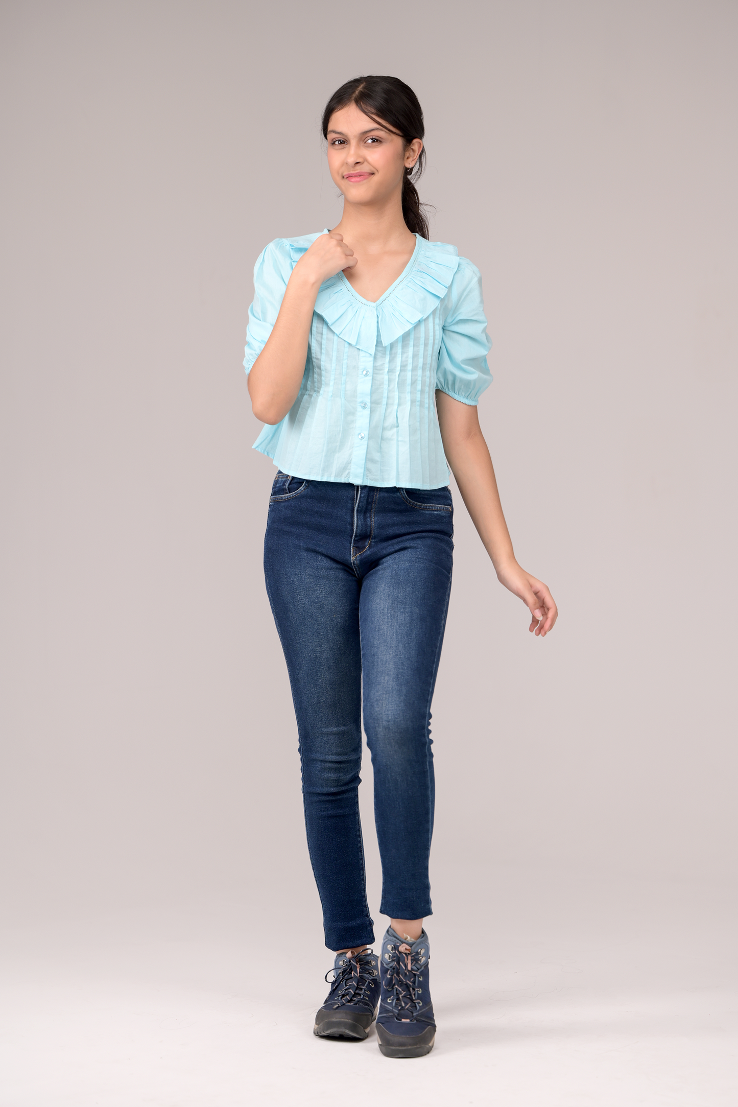 V‑neck top crowned with a dramatic ruffle