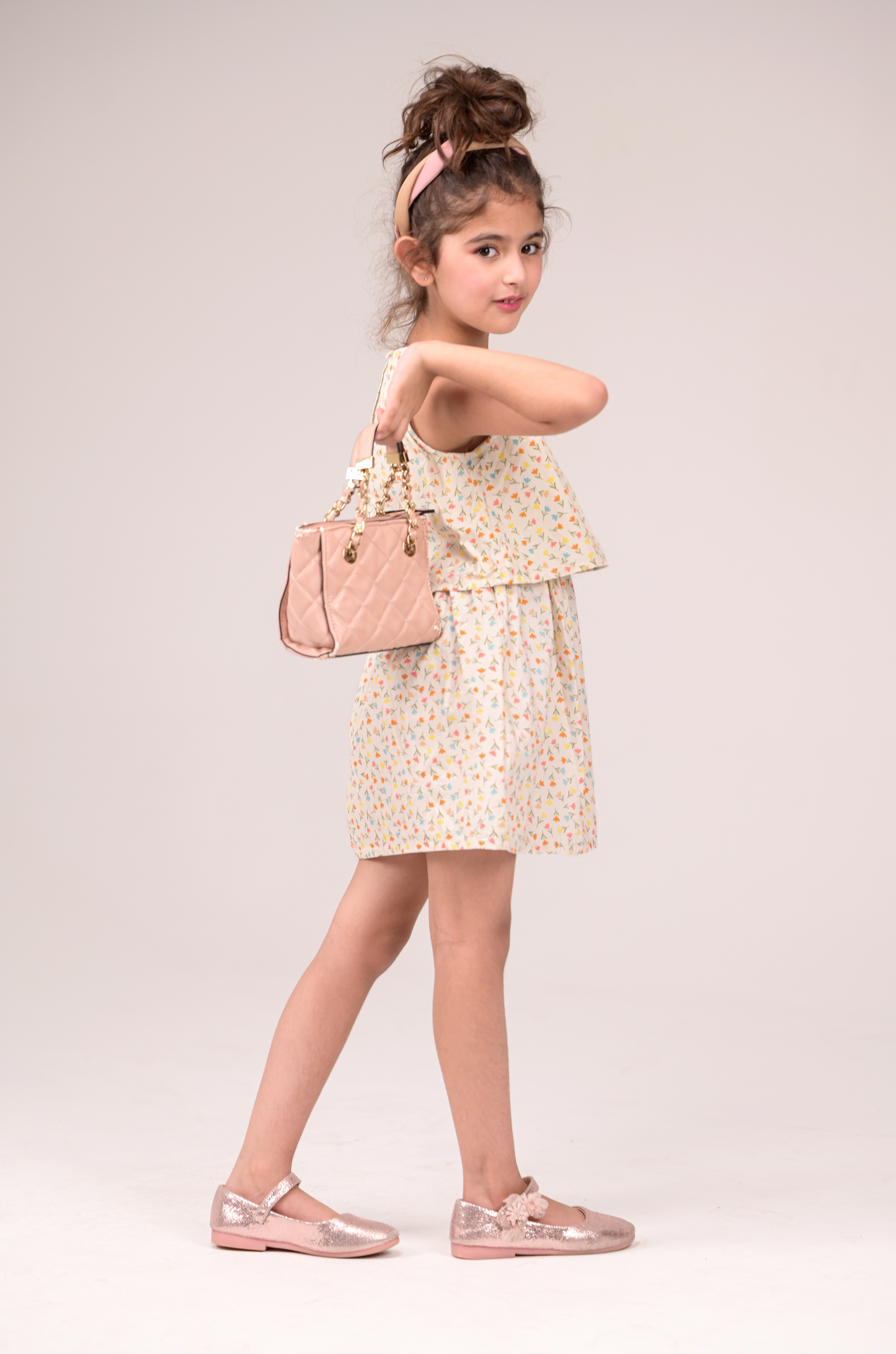 Sleeveless frock with a gentle V‑neck and two flowing layers