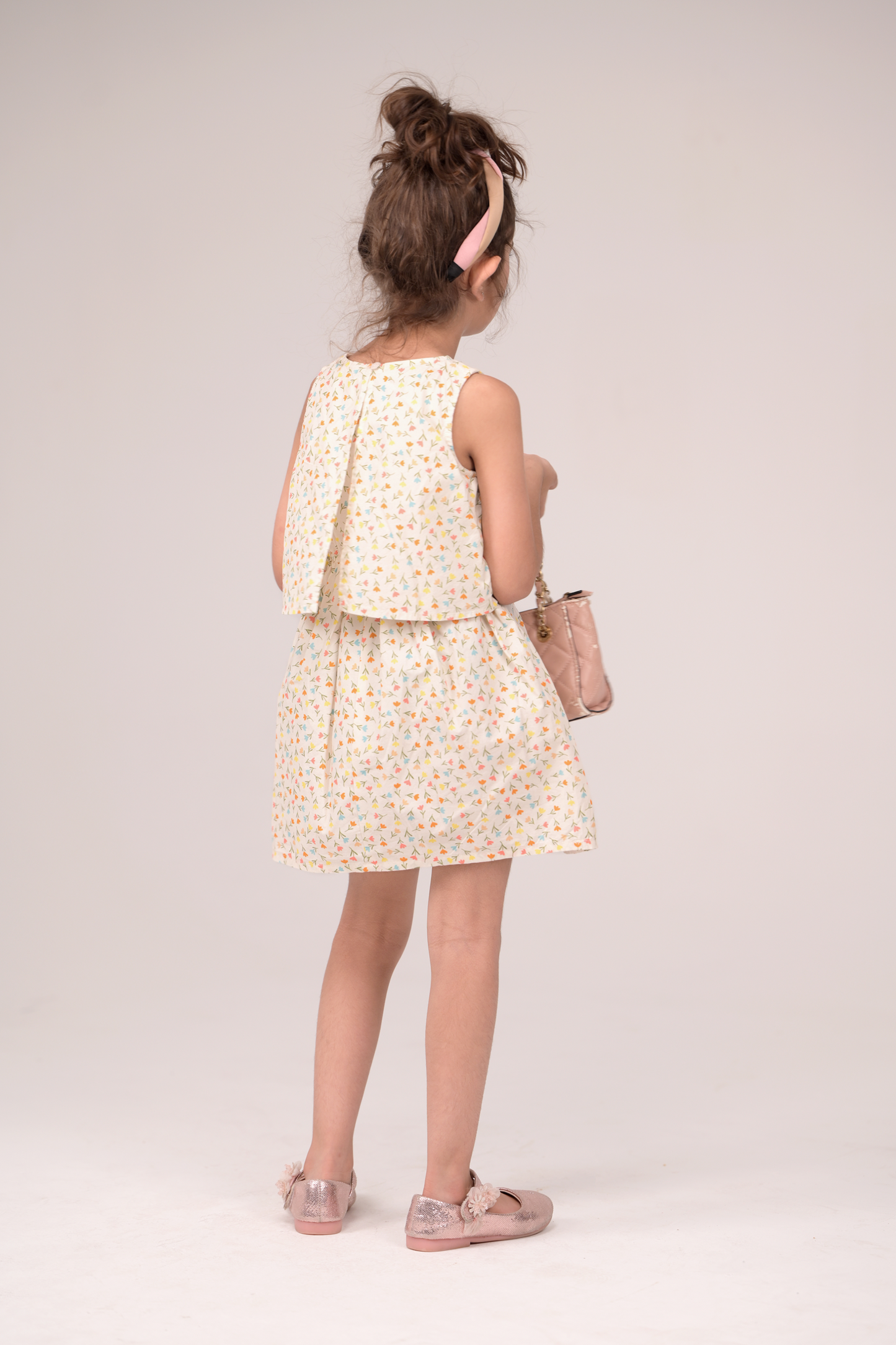 Sleeveless frock with a gentle V‑neck and two flowing layers