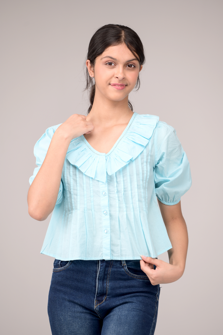 V‑neck top crowned with a dramatic ruffle
