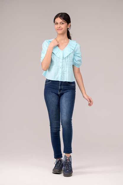 V‑neck top crowned with a dramatic ruffle